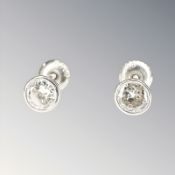A pair of 18ct white gold diamond stud earrings, the total diamond weight estimated at 0.