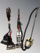 Two Shark vacuum cleaners and a Daewoo vacuum.