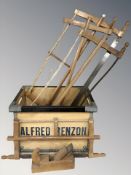 A plywood crate containing vintage hand saws, a woodworking plane, etc.