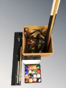 A pine box containing billiards cues, balls, triangles, etc.