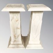 A pair of faux marble pedestals, height 68 cm.