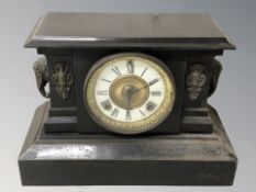 A Victorian black slate mantel clock with enameled dial, height 26 cm.