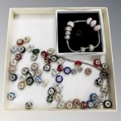 A charm bracelet in Pandora box and assorted loose charms stamped 925.