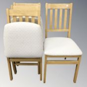 A set of four modern folding chairs.