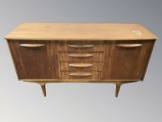 A 20th century teak bow front sideboard fitted cupboards and drawers, 137 cm W x 46 cm D x 78 cm H.