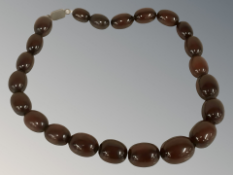 A cherry amber/Bakelite bead necklace with silver clasp