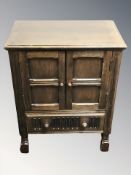 A 20th century oak linen fold low cabinet, width 53 cm.