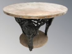 A cast iron and copper topped pub-style coffee table, diameter 57 cm.