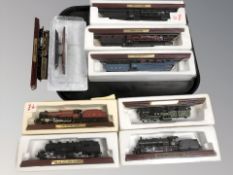 Eight various scale model locomotives on plinths and a further battleship model