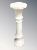 An onyx pedestal, height 93 cm.