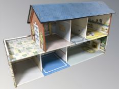 An enameled tin doll's house, width 63 cm.