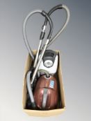 A Nilfisk vacuum and a Miele vacuum (continental plugs)