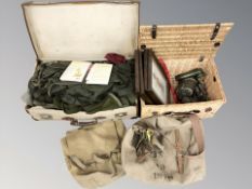 A wicker hamper and canvas luggage case containing militaria including frame prints, canteen, torch,