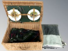A wicker picnic hamper and contents
