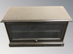 A contemporary ebonised and glazed entertainment cabinet, 99 cm W x 46 D x 58 cm H.
