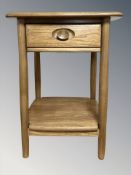 An Ercol light elm single drawer bedside lamp table, 50 cm W x 45 cm D x 65 cm H.