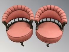 A pair of early 20th century ebonised salon armchairs, in braided pink fabric, width 67 cm.