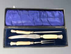 A cased three-piece carving set with antler handles