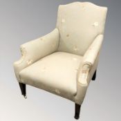 An Edwardian library armchair in the manner of Howard & Sons,