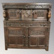 An early 20th century heavily carved and stained oak court cupboard 164 cm x 58 cm x 172 cm