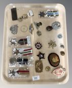 A group of military related badges, medals, collectables to include Russian badges,