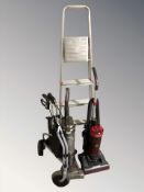 A Vax upright vacuum cleaner, a Hoover vacuum,