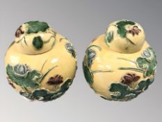 A pair of 20th century Chinese yellow glazed earthen ware ginger jars,