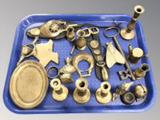 A group of brass candlesticks, horse brasses,