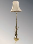A brass Art Nouveau style standard lamp