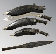 Three Indian kukris in sheathes, largest with 28 cm blade,