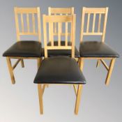 A contemporary set of four oak dining chairs