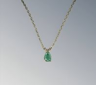 A 10ct gold emerald pendant on chain,