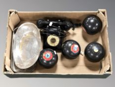 A group of four lawn bowls, vintage telephone,