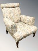 An Edwardian library armchair in floral upholstery,