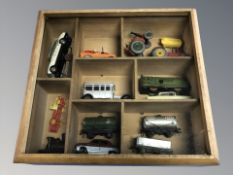A glazed wooden display case containing die cast cars