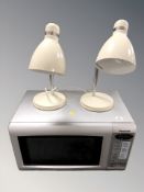 A Panasonic microwave and pair of angle-poise lamps