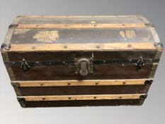 An early 20th century wood and canvas dome toped trunk,