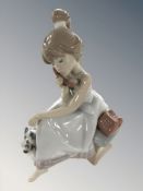 A Lladro figure of a girl on the telephone,