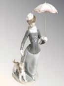 A large Lladro figure - Lady with parasol walking a dog,