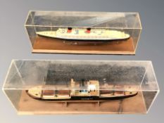 Two scale model ships in display cases,