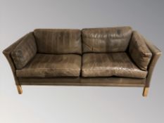 A late 20th century Danish brown stitched leather three seater settee,
