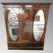 An Edwardian mahogany and satinwood banded triple door wardrobe,