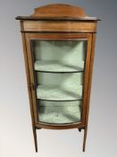 A late Victorian mahogany satinwood inlaid bow fronted display cabinet,
