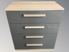 A modern grey laminated four drawer chest,