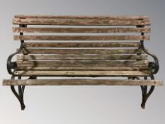 A wrought metal and teak garden bench,