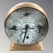 A brass World Time mantel timepiece / compass,
