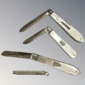 Three silver-bladed mother of pearl fruit knives and a silver toothpick