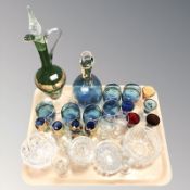 A gilt blue glass ewer and six matching cups, another ewer and similar glasses,