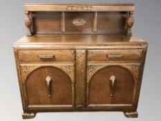 A 1930's carved oak dining room suite comprising of buffet sideboard, 137 cm x 52 cm x 130 cm,