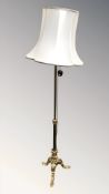 An ornate gilt metal standard lamp on paw feet, height 174 cm.
